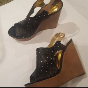 Carlos Santana black wedges with gold studs